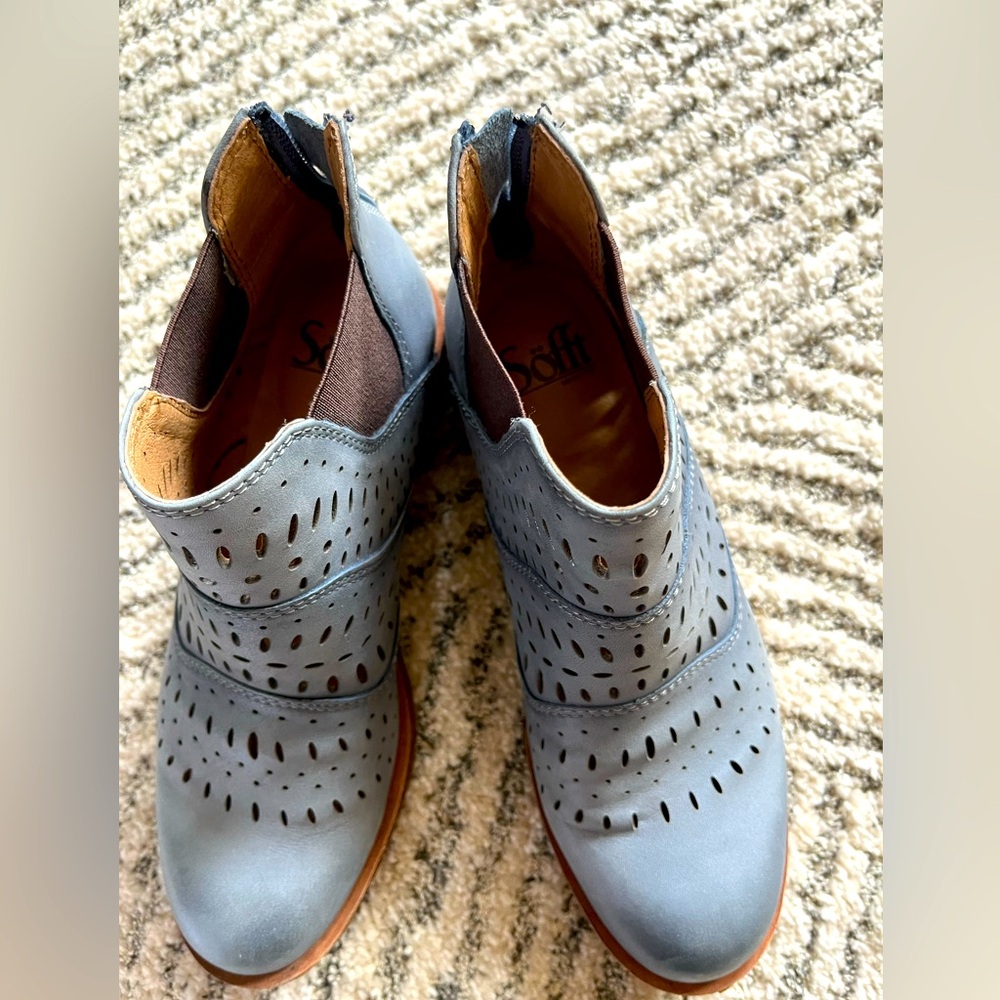 Bluish,grey booties with cut out details.